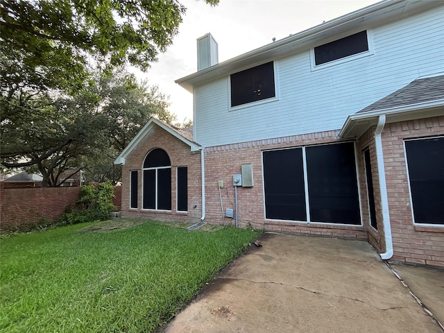 17427 Marigold Dr, Sugar Land, TX 77479 - rear view of property with a chimney, a yard, a patio area, and brick siding