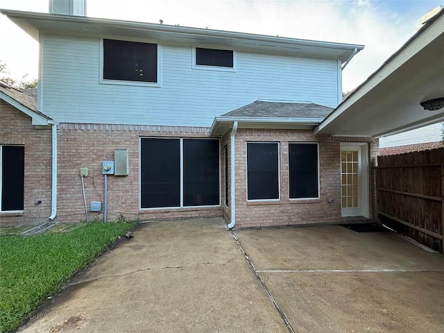 17427 Marigold Dr, Sugar Land, TX 77479 - rear view of house with a patio area, brick siding, and a shingled roof