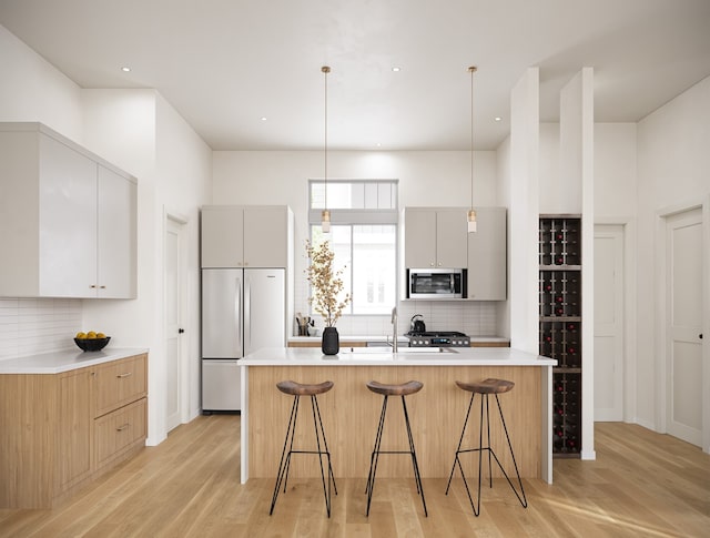 2125D Hoskins Dr, Houston, TX 77080 - kitchen featuring stainless steel microwave, fridge, tasteful backsplash, gray cabinetry, and recessed lighting