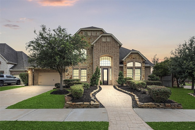 3102 Hillside Landing Trl, Katy, TX 77494 - french provincial home featuring brick siding, concrete driveway, an attached garage, and stone siding