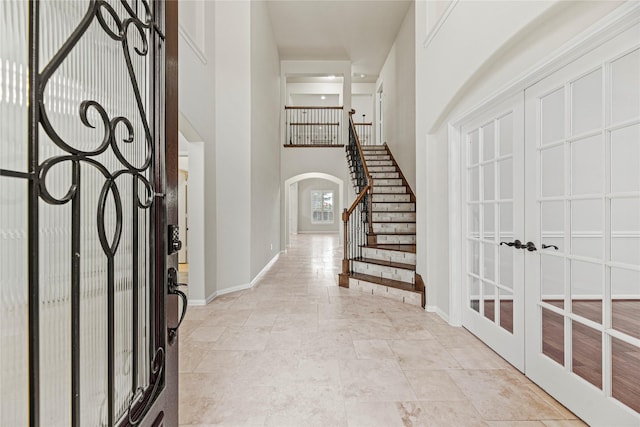 3102 Hillside Landing Trl, Katy, TX 77494 - entryway with arched walkways, stairs, a towering ceiling, and french doors