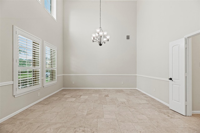 3102 Hillside Landing Trl, Katy, TX 77494 - unfurnished room with a high ceiling, a chandelier, and stone finish floors