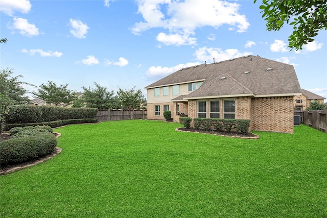 3102 Hillside Landing Trl, Katy, TX 77494 - back of property with brick siding, a fenced backyard, and a shingled roof