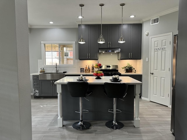 7923 Harvester St, Houston, TX 77095 - kitchen featuring stainless steel range oven, under cabinet range hood, ornamental molding, freestanding refrigerator, and backsplash