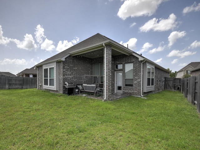 6127 Rosehill Harvest Loop, Katy, TX 77493 - back of house featuring brick siding and a fenced backyard