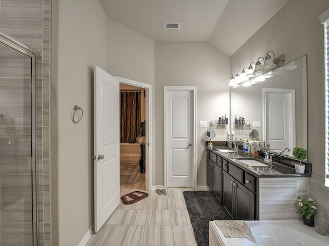 6127 Rosehill Harvest Loop, Katy, TX 77493 - bathroom with vaulted ceiling, double vanity, a tub to relax in, a shower with door, and tile patterned floors