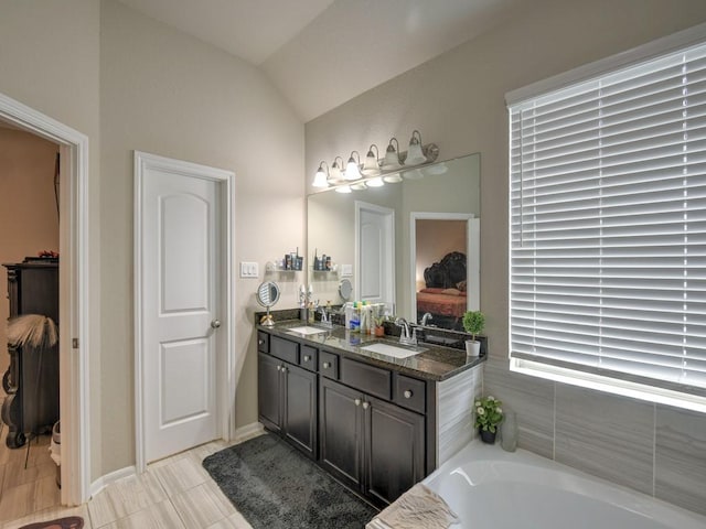 6127 Rosehill Harvest Loop, Katy, TX 77493 - full bathroom with double vanity, lofted ceiling, and a bath