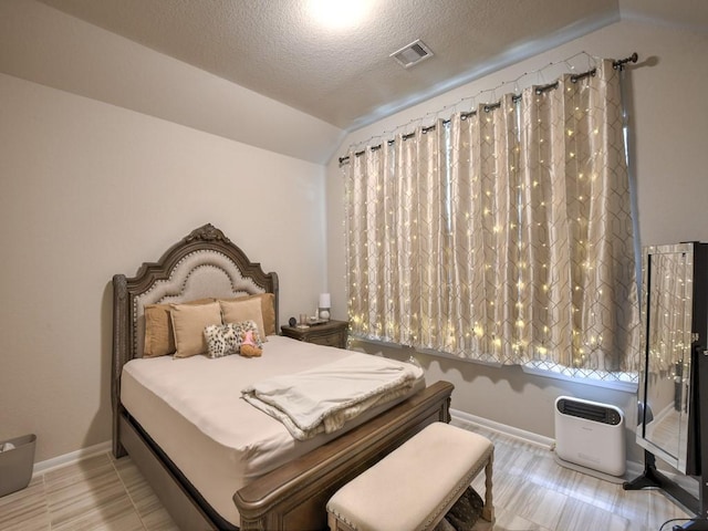 6127 Rosehill Harvest Loop, Katy, TX 77493 - bedroom with lofted ceiling and a textured ceiling