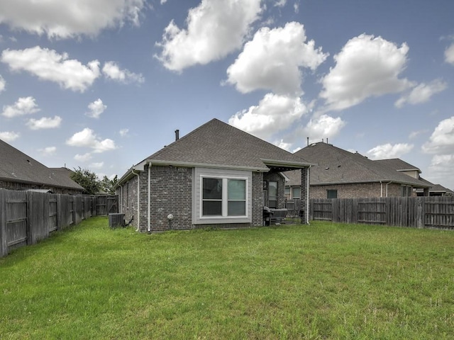 6127 Rosehill Harvest Loop, Katy, TX 77493 - back of house featuring a fenced backyard, brick siding, and a shingled roof