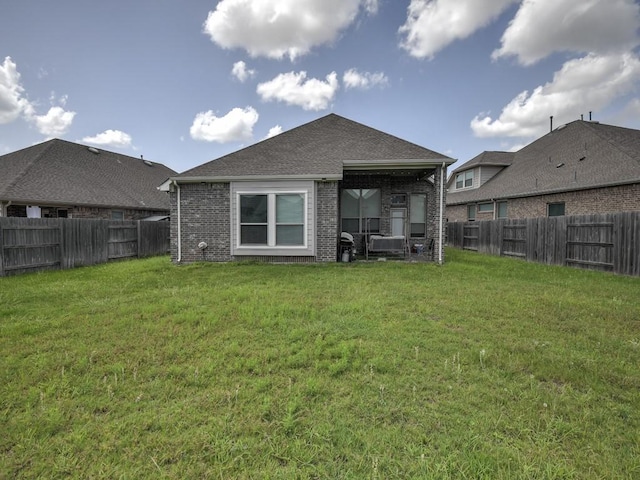 6127 Rosehill Harvest Loop, Katy, TX 77493 - rear view of property with a fenced backyard, brick siding, and a shingled roof