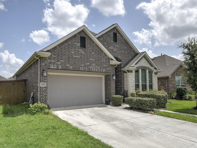 6127 Rosehill Harvest Loop, Katy, TX 77493 - view of front of house with concrete driveway, brick siding, a garage, and stone siding