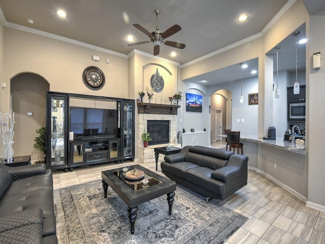 6127 Rosehill Harvest Loop, Katy, TX 77493 - living area with arched walkways, a ceiling fan, a fireplace, recessed lighting, and tile patterned floors