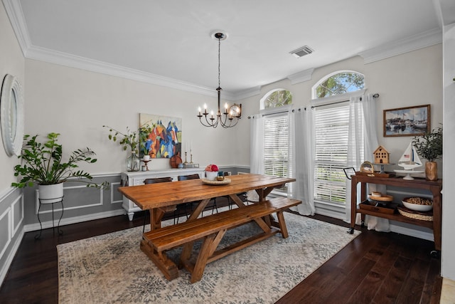 2413 Sawgrass Ct, League City, TX 77573 - dining space featuring dark wood-style floors, a chandelier, ornamental molding, and wainscoting