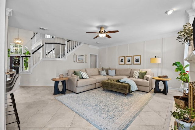 2413 Sawgrass Ct, League City, TX 77573 - living room featuring ceiling fan, stairway, light tile patterned floors, a chandelier, and ornamental molding