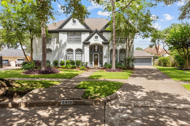 2413 Sawgrass Ct, League City, TX 77573 - french provincial home with a front yard, roof with shingles, and brick siding