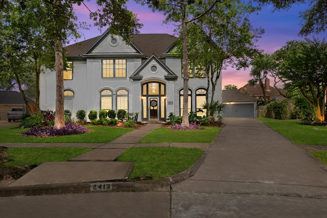 2413 Sawgrass Ct, League City, TX 77573 - french country home with a front yard, brick siding, and a detached garage