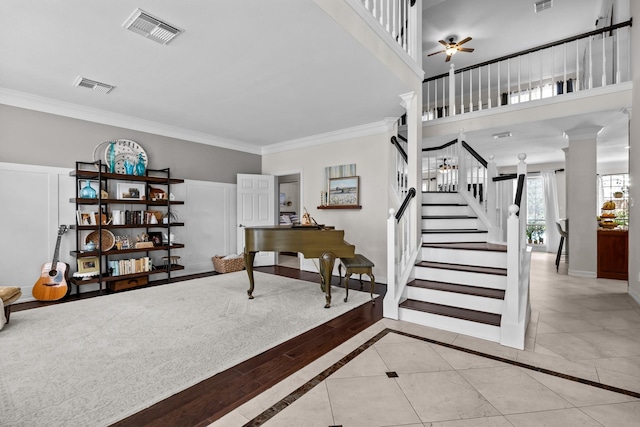 2413 Sawgrass Ct, League City, TX 77573 - staircase with crown molding, a ceiling fan, and ornate columns