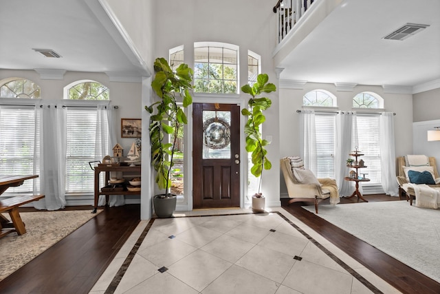 2413 Sawgrass Ct, League City, TX 77573 - entryway featuring a high ceiling, inlaid floor details, and ornamental molding