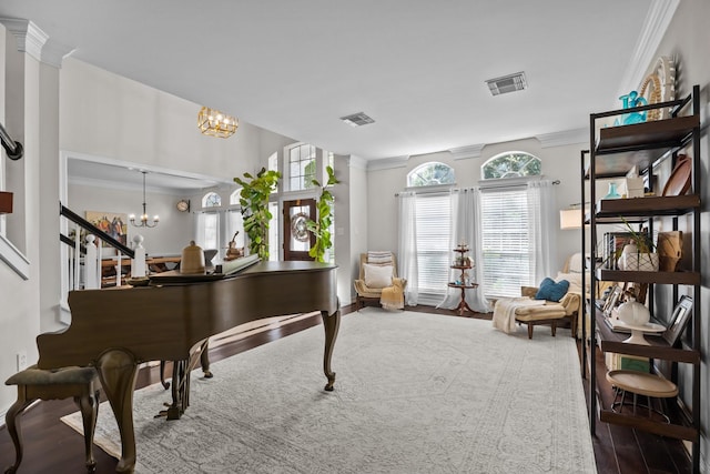 2413 Sawgrass Ct, League City, TX 77573 - living area featuring a chandelier, crown molding, wood finished floors, and stairway