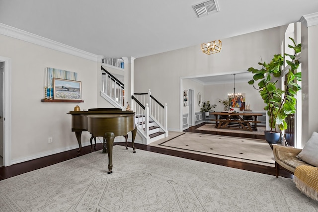 2413 Sawgrass Ct, League City, TX 77573 - entryway featuring a chandelier, stairs, wood finished floors, and crown molding