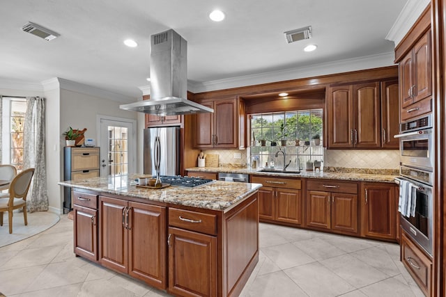 2413 Sawgrass Ct, League City, TX 77573 - kitchen with island range hood, stainless steel appliances, a kitchen island, backsplash, and ornamental molding