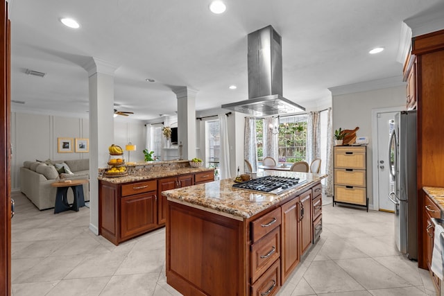 2413 Sawgrass Ct, League City, TX 77573 - kitchen featuring island exhaust hood, stainless steel appliances, a kitchen island, ornate columns, and healthy amount of natural light