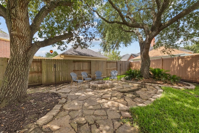 2413 Sawgrass Ct, League City, TX 77573 - fenced backyard featuring a patio area and a fire pit