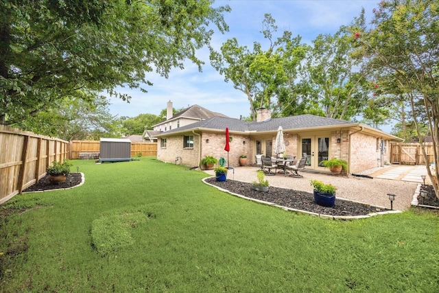 12502 Nova Dr, Houston, TX 77077 - rear view of house featuring french doors, brick siding, a chimney, a fenced backyard, and a patio