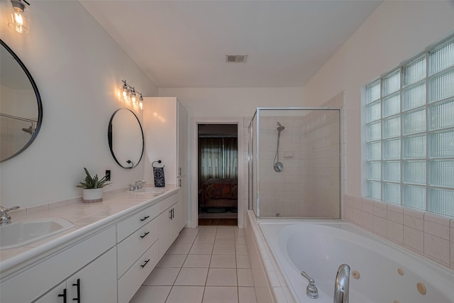 308 Dennis St, Houston, TX 77006 - ensuite bathroom with a jetted tub, double vanity, tile patterned floors, and a tile shower