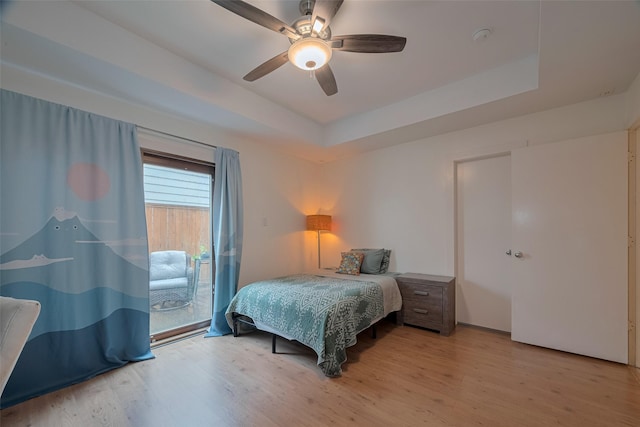 308 Dennis St, Houston, TX 77006 - bedroom with access to outside, wood finished floors, a raised ceiling, and a ceiling fan