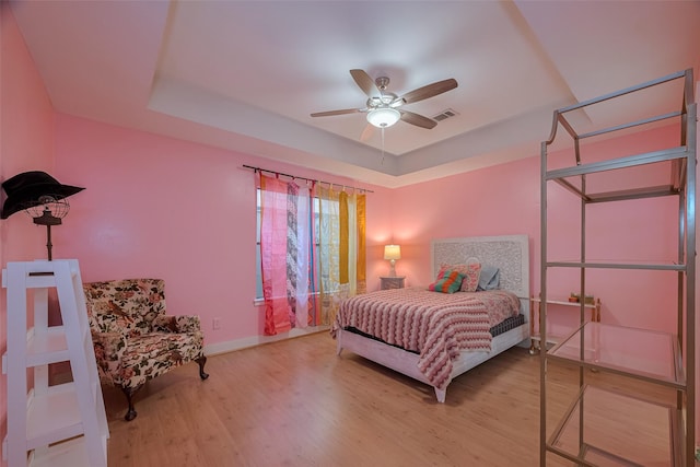 308 Dennis St, Houston, TX 77006 - bedroom with a raised ceiling, wood finished floors, and a ceiling fan