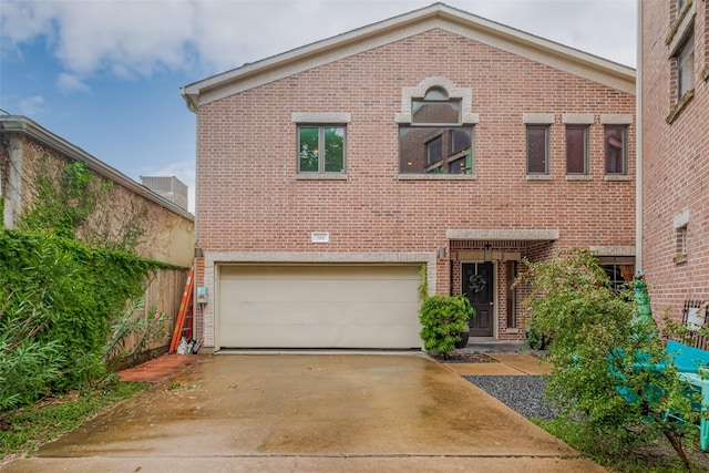 308 Dennis St, Houston, TX 77006 - traditional-style house with brick siding, an attached garage, and driveway