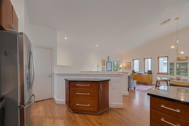 308 Dennis St, Houston, TX 77006 - kitchen featuring stainless steel fridge, a peninsula, light wood-style flooring, open floor plan, and lofted ceiling