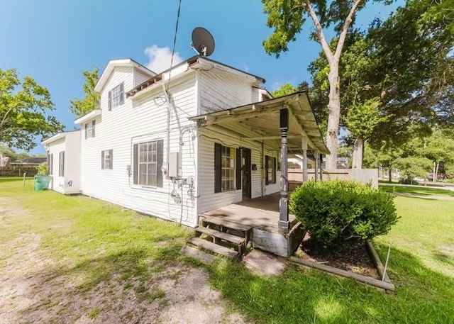 222 E Southland Ave, Alvin, TX 77511 - back of property featuring a lawn and covered porch