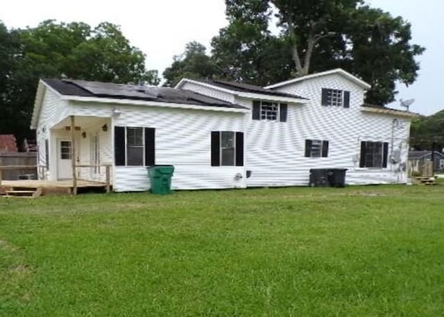 222 E Southland Ave, Alvin, TX 77511 - rear view of house with a lawn and a wooden deck