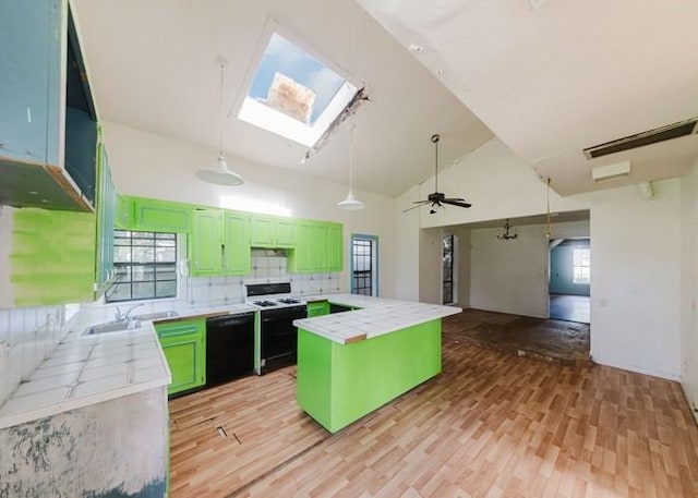 222 E Southland Ave, Alvin, TX 77511 - kitchen with stove, dishwasher, tile countertops, green cabinets, and light wood finished floors