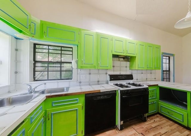 222 E Southland Ave, Alvin, TX 77511 - kitchen with black dishwasher, range with gas stovetop, light countertops, green cabinetry, and light wood-style floors