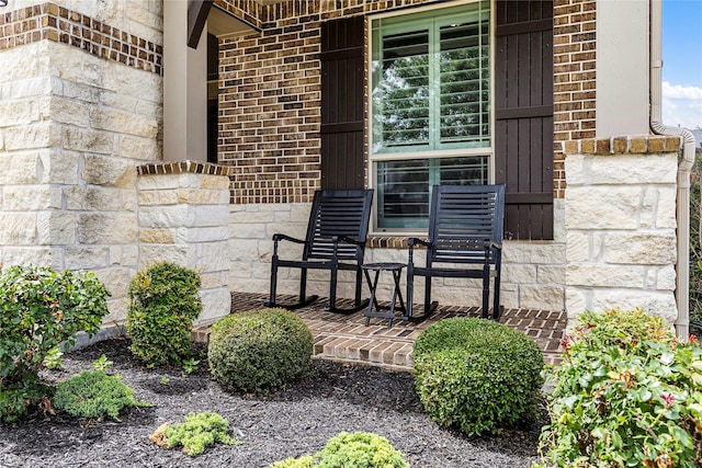 13819 Windward Harbor Ct, Houston, TX 77059 - view of exterior entry featuring a porch, brick siding, and stone siding