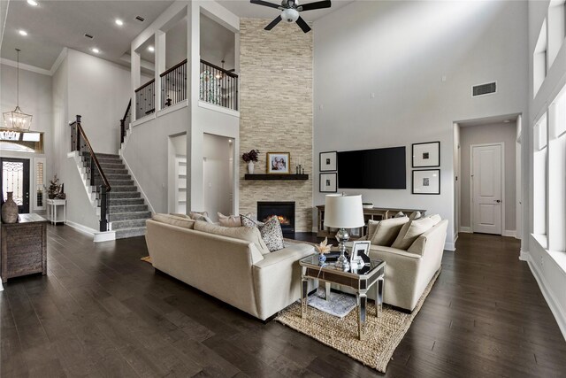 13819 Windward Harbor Ct, Houston, TX 77059 - living area featuring a high ceiling, healthy amount of natural light, a stone fireplace, stairs, and dark wood-style floors