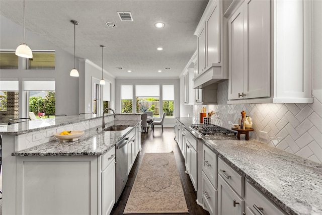 13819 Windward Harbor Ct, Houston, TX 77059 - kitchen with appliances with stainless steel finishes, dark wood finished floors, a large island, backsplash, and white cabinets