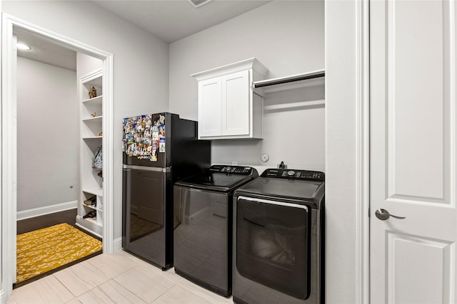 13819 Windward Harbor Ct, Houston, TX 77059 - washroom featuring cabinet space, separate washer and dryer, and light tile patterned floors