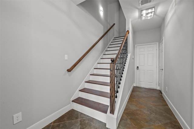 2338 Bastrop St, Houston, TX 77004 - stairs featuring baseboards and stone finish floors