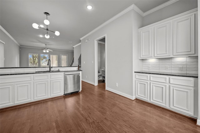 2338 Bastrop St, Houston, TX 77004 - kitchen featuring dishwasher, ornamental molding, decorative backsplash, dark wood finished floors, and white cabinets