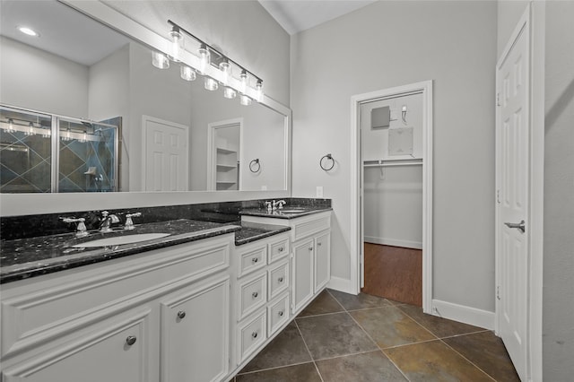 2338 Bastrop St, Houston, TX 77004 - full bath with double vanity, a shower stall, a walk in closet, and tile patterned flooring