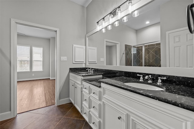 2338 Bastrop St, Houston, TX 77004 - bathroom with double vanity, a stall shower, and tile patterned flooring