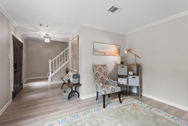 3715 Ember Spring Dr, Kingwood, TX 77339 - sitting room featuring wood finished floors, crown molding, and stairway