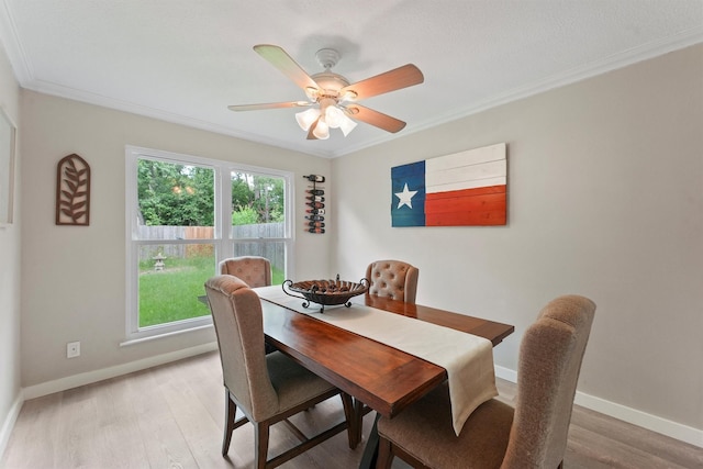 3715 Ember Spring Dr, Kingwood, TX 77339 - dining area featuring ornamental molding, light wood-style floors, and a ceiling fan