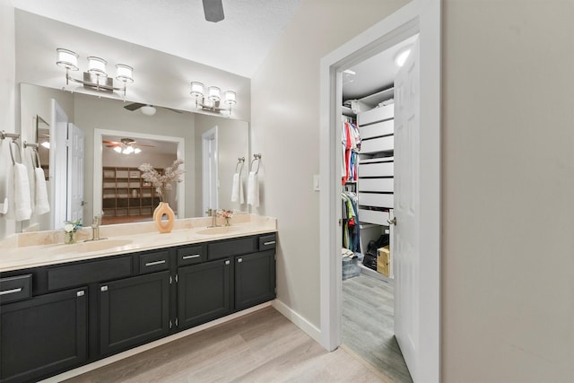 3715 Ember Spring Dr, Kingwood, TX 77339 - full bath with ceiling fan, wood finished floors, double vanity, and a walk in closet