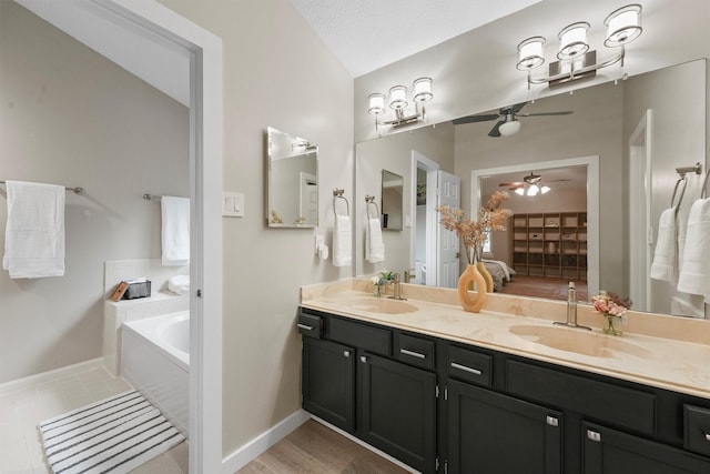 3715 Ember Spring Dr, Kingwood, TX 77339 - bathroom with double vanity, a bath, ceiling fan, and tile patterned flooring
