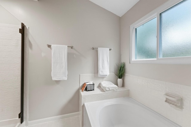 3715 Ember Spring Dr, Kingwood, TX 77339 - full bathroom with a garden tub, vaulted ceiling, and a stall shower